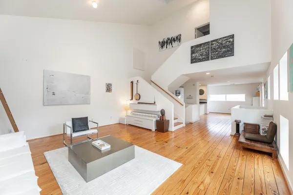a living room with furniture and a wooden floor