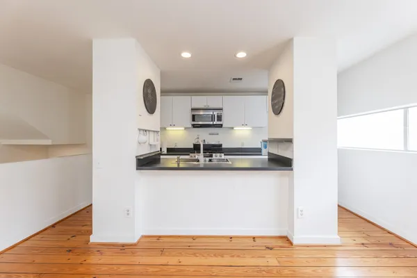 a kitchen with stainless steel appliances granite countertop a sink and a wooden cabinets