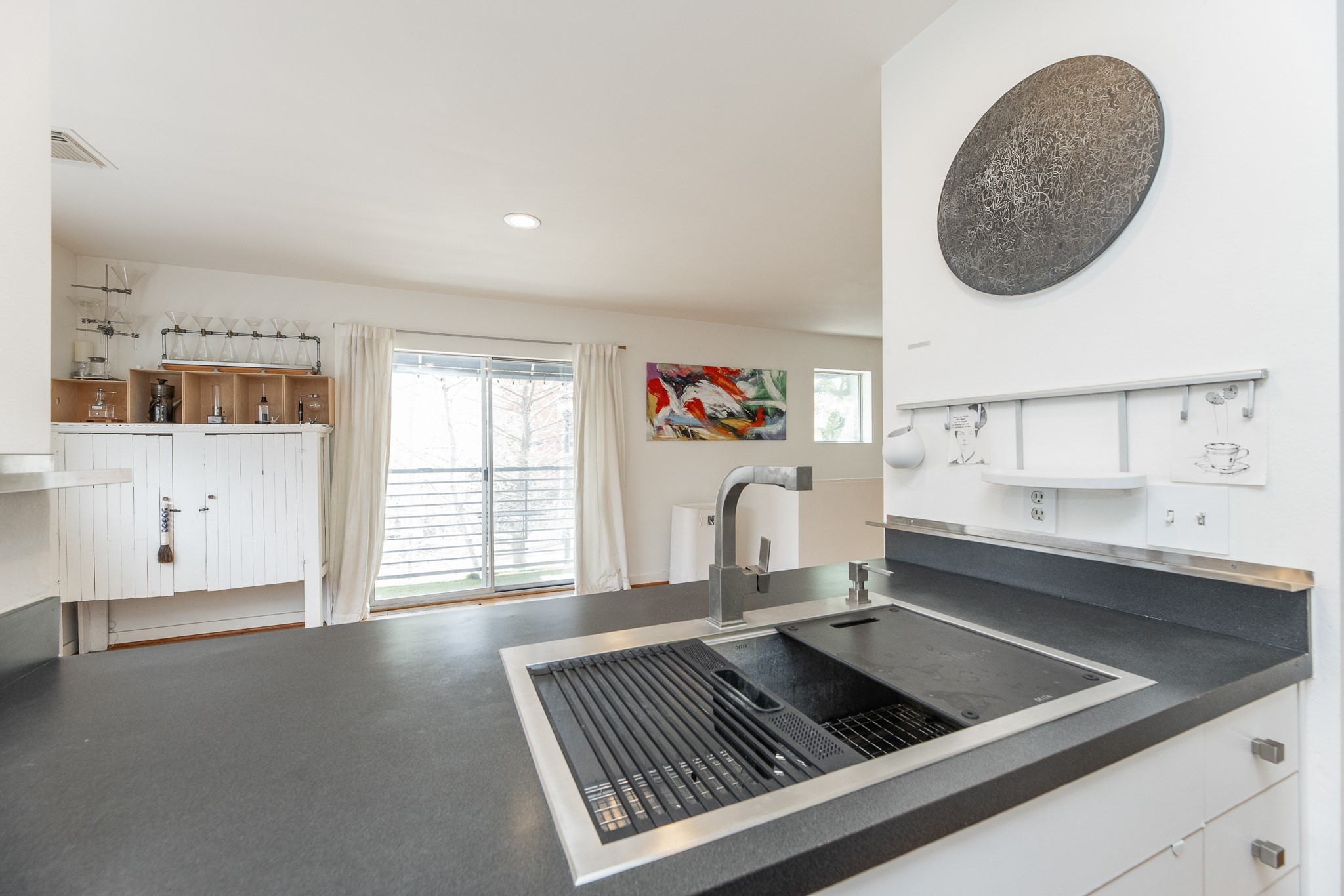 2714 Chenevert Street Houston, TX 77004 - Photo 19 of 40 a kitchen with a sink cabinets and a large window