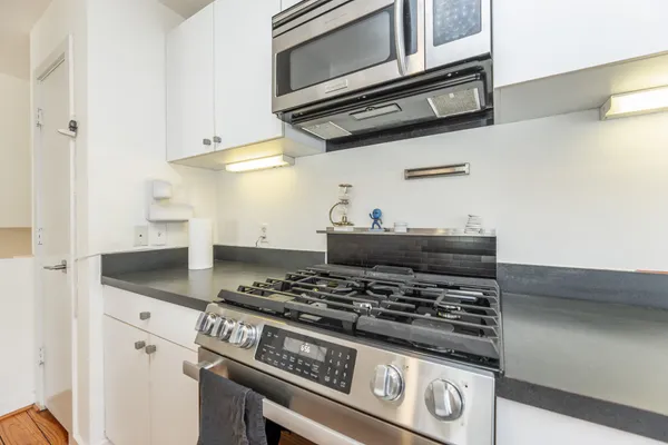 a stove top oven sitting inside of a kitchen