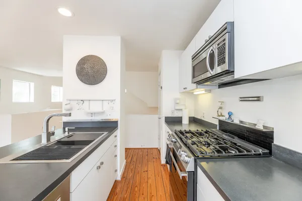 a kitchen with a stove and a sink