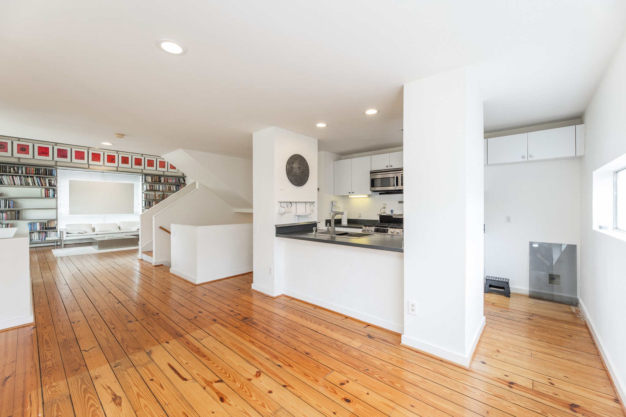 2714 Chenevert Street Houston, TX 77004 - Photo 23 of 40 a view of a kitchen with kitchen island a sink wooden floor and stainless steel appliances