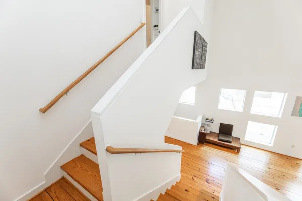 a living room with wooden floor and a large window