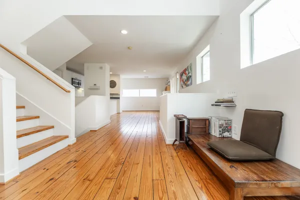 a living room with furniture and a wooden floor
