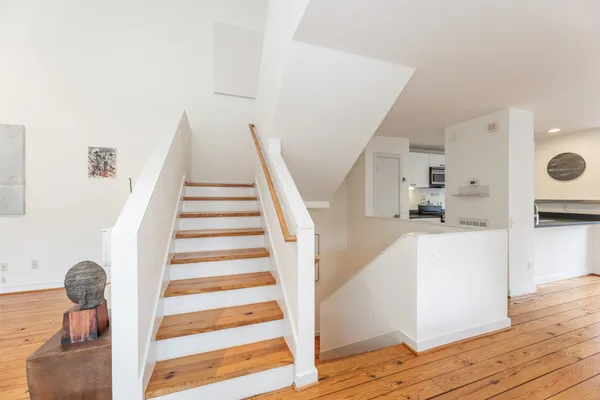 a view of entryway and hall with wooden floor