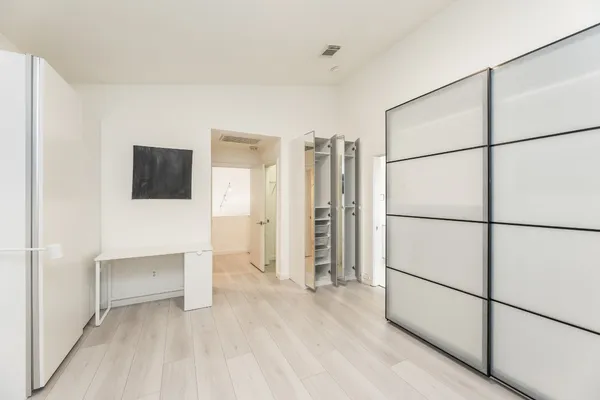 a view of empty room with a white walls