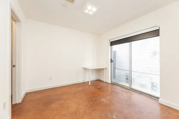 an empty room with a empty space and a window