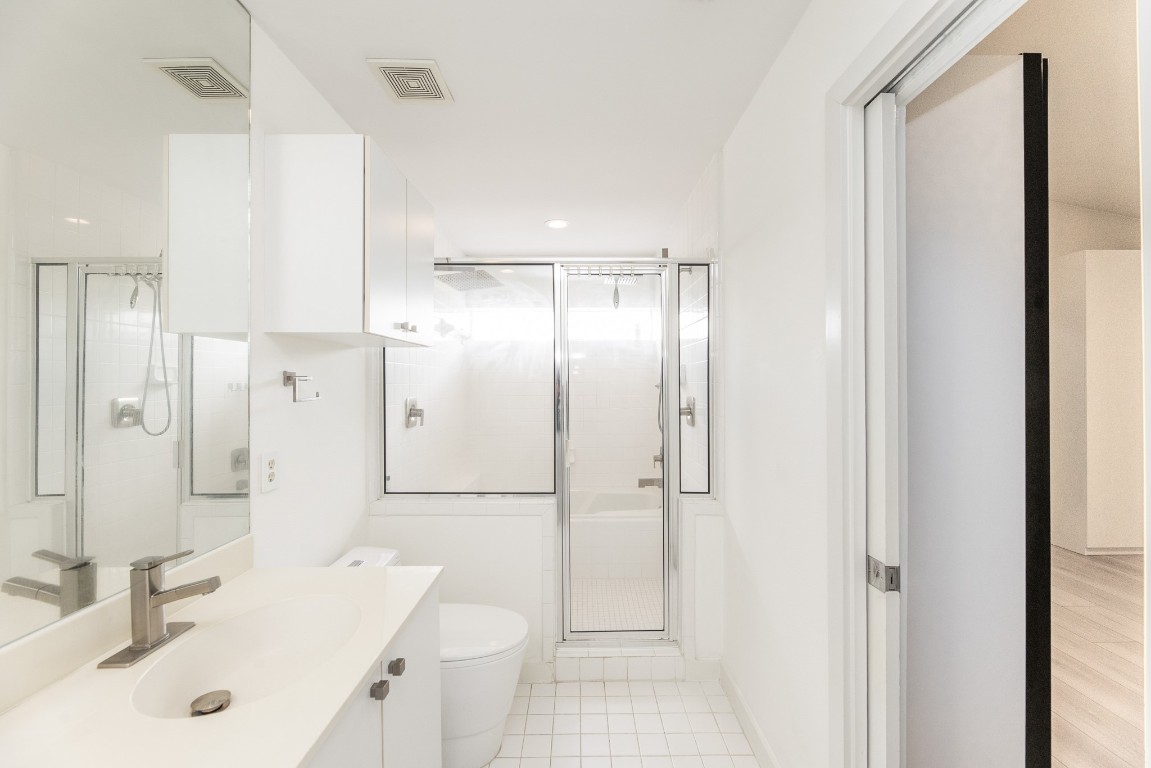 2714 Chenevert Street Houston, TX 77004 - Photo 33 of 40 a bathroom with a sink a toilet and shower