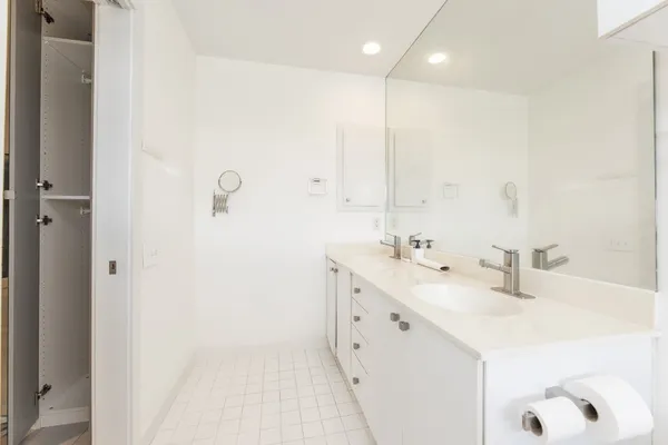 a bathroom with a double vanity sink mirror and