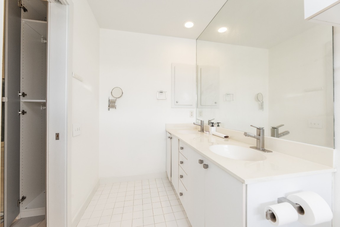 2714 Chenevert Street Houston, TX 77004 - Photo 37 of 40 a bathroom with a double vanity sink mirror and