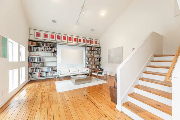 a very nice looking room with a large window and wooden floor
