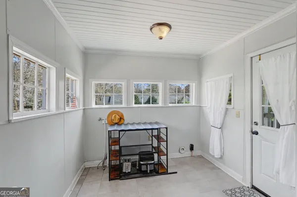 a view of room with window and furniture