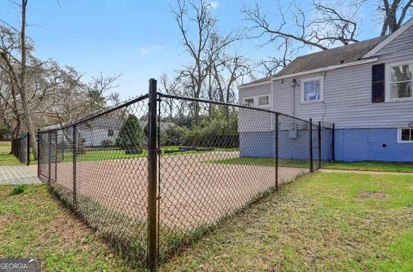 a view of a backyard with wooden fence