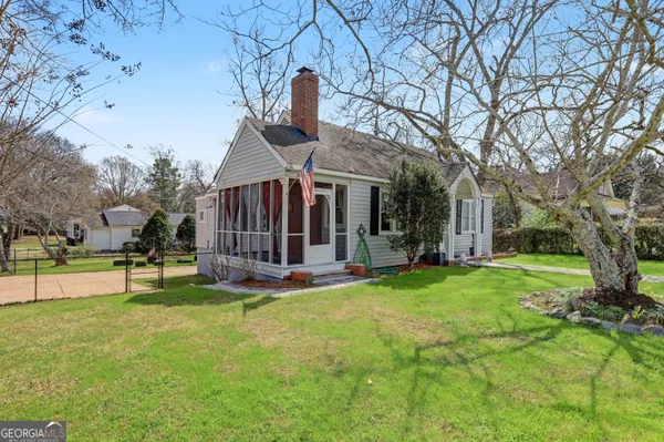 a view of a house with a yard patio and fire pit