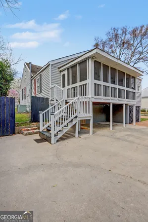a view of a house with a yard and fence
