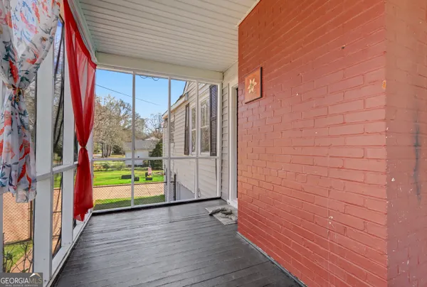 a view of an entryway with wooden floor and door