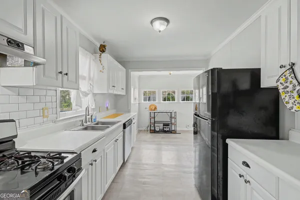 a kitchen with a refrigerator and a stove