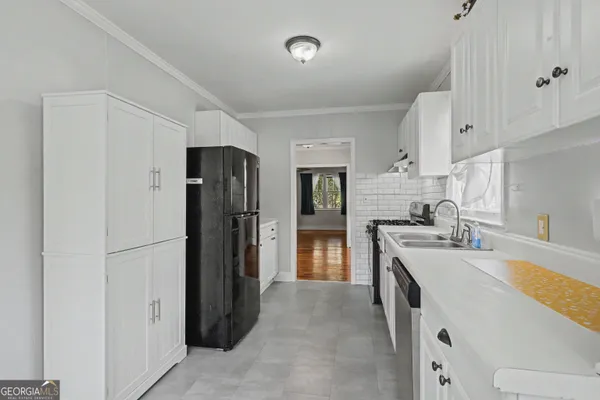 a kitchen with a refrigerator and a sink