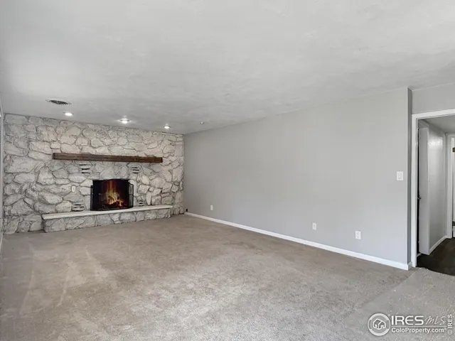 a view of an empty room with a fireplace