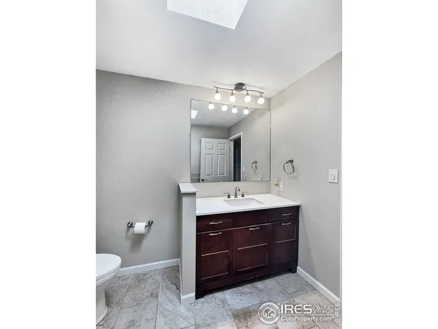 a bathroom with a double vanity sink and mirror