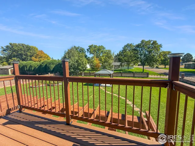 a view of balcony with wooden floor and fence