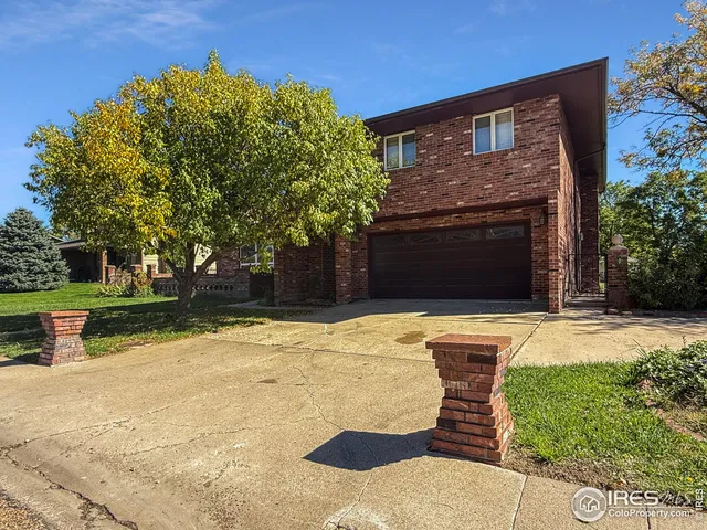a front view of a house with yard yard and tree