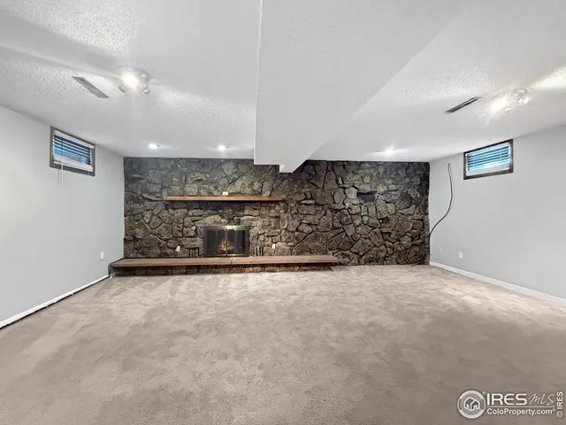 a view of an empty room with a fireplace