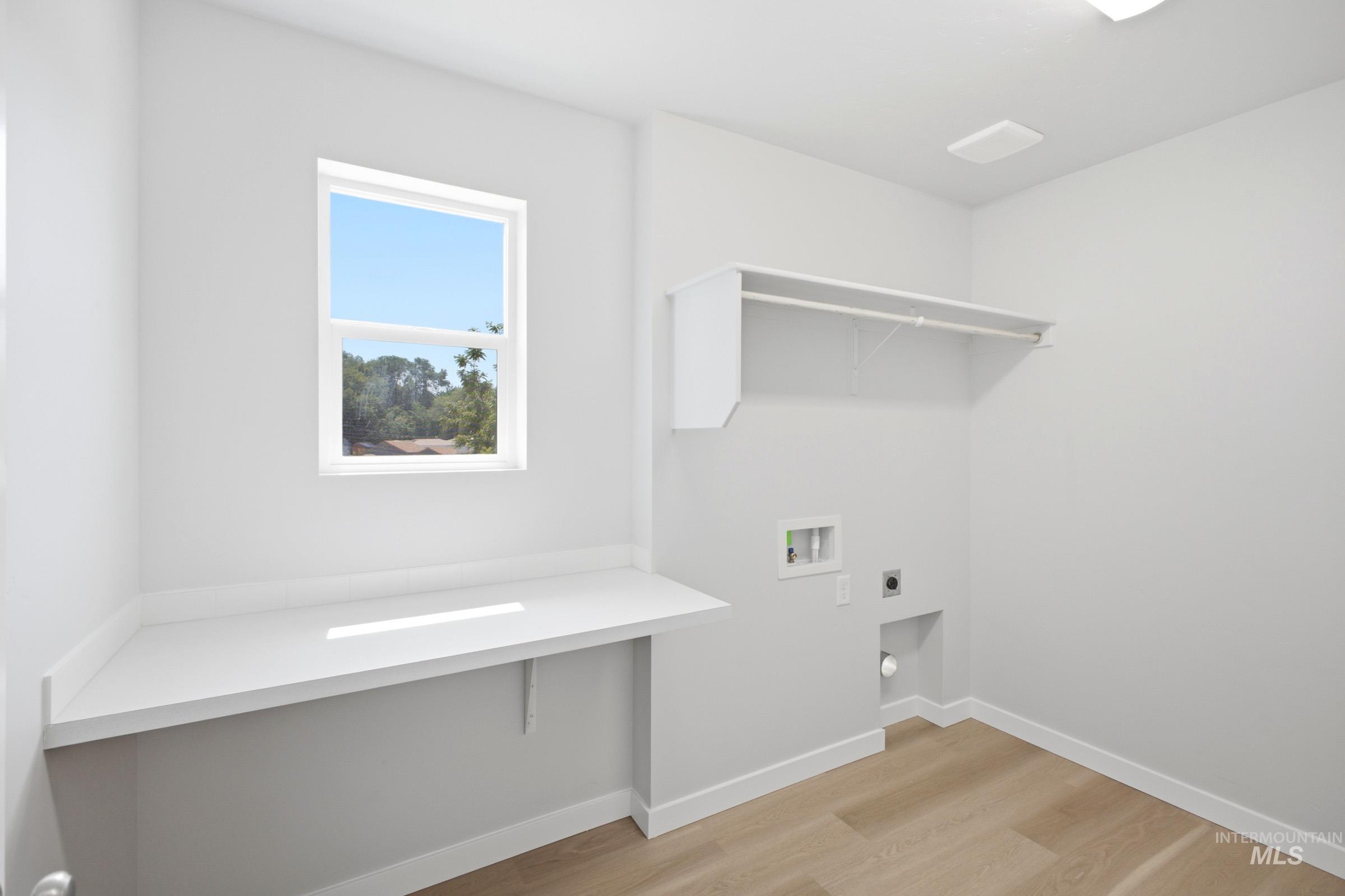 13336 Bank Street Caldwell, ID 83607 - Photo 19 of 24 Dedicated laundry area featuring a built-in folding counter, upper shelving, and a single window
