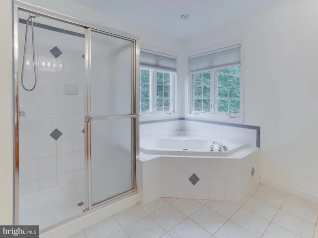 a bath tub sitting next to a shower