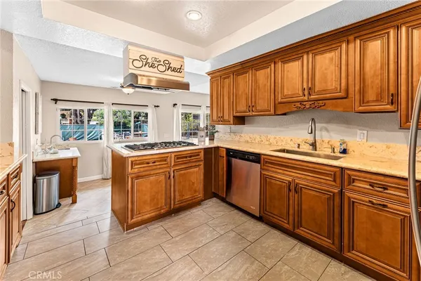 a kitchen with stainless steel appliances granite countertop a stove sink and cabinets