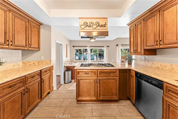 a kitchen with stainless steel appliances granite countertop a sink and cabinets