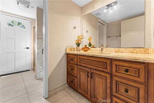 a bathroom with a sink a vanity and a mirror