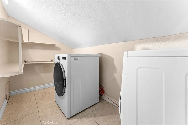 a spacious bedroom with a bed and wooden floor