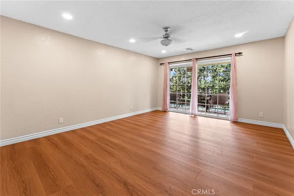 a view of an empty room with wooden floor