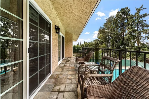 a view of a house with pool fire pit a patio and a yard