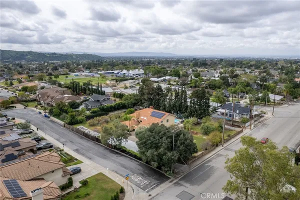 an aerial view of residential houses with outdoor space and river