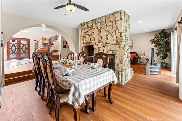a view of a a dining room with furniture window and wooden floor