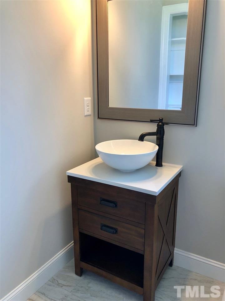 3717 Massey Ridge Court Raleigh, NC 27616 - Photo 11 of 24 a bathroom with a sink and a mirror