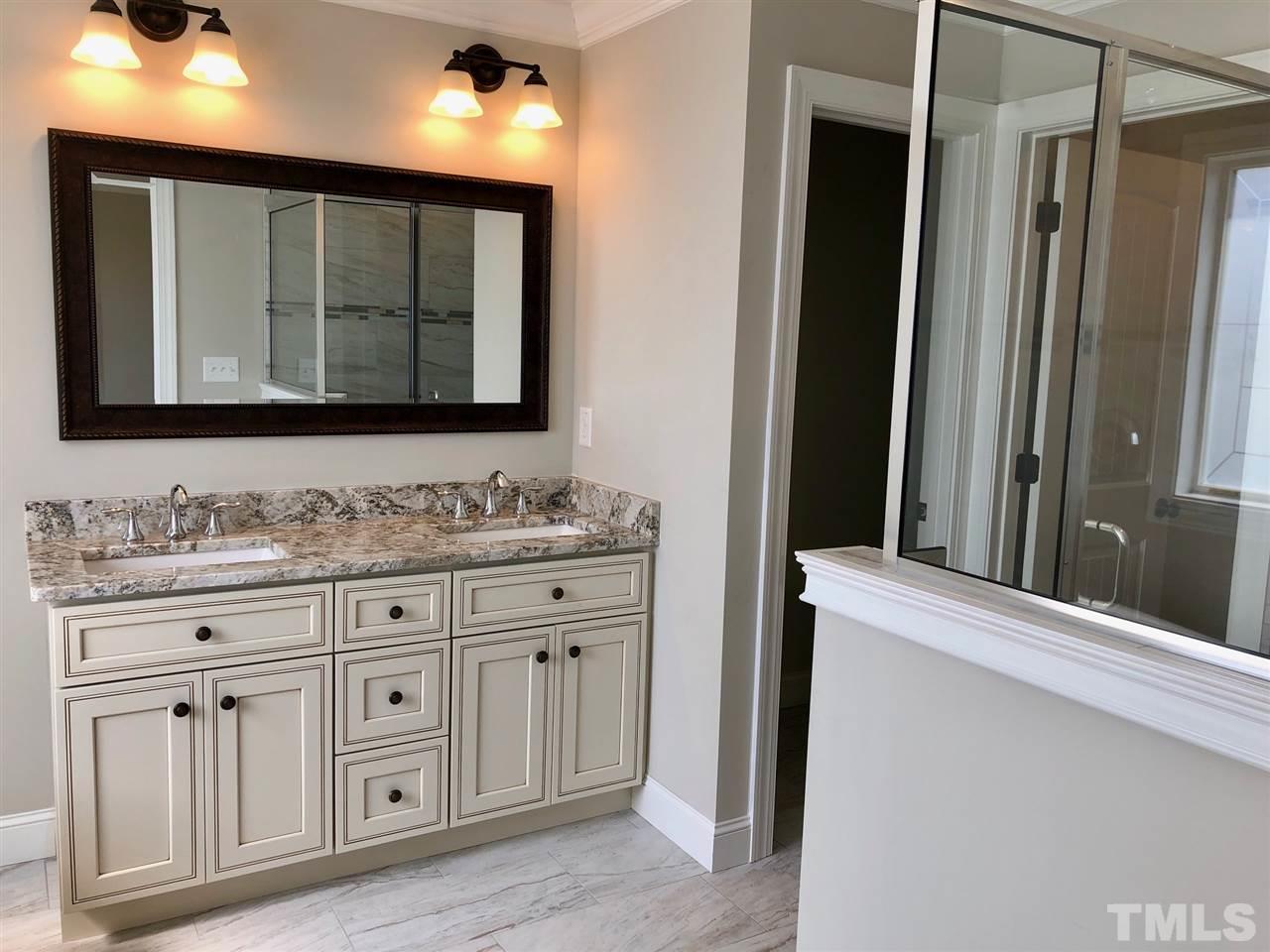 3717 Massey Ridge Court Raleigh, NC 27616 - Photo 14 of 24 a bathroom with a sink vanity and mirror