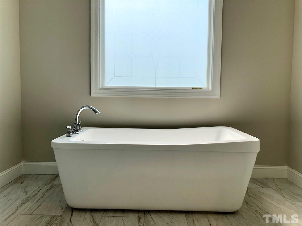 3717 Massey Ridge Court Raleigh, NC 27616 - Photo 17 of 24 a white tub sitting next to a window