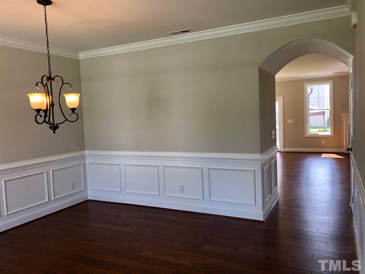 3717 Massey Ridge Court Raleigh, NC 27616 - Photo 3 of 24 a view of an empty room with wooden floor and a window
