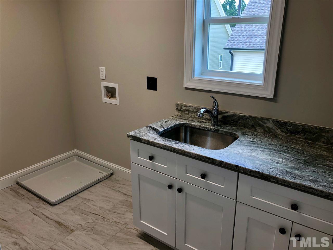 3717 Massey Ridge Court Raleigh, NC 27616 - Photo 21 of 24 a kitchen with a sink and cabinets