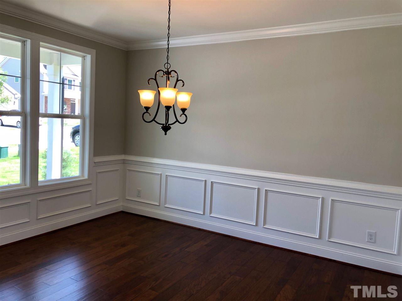 3717 Massey Ridge Court Raleigh, NC 27616 - Photo 4 of 24 a view of an empty room with wooden floor and window