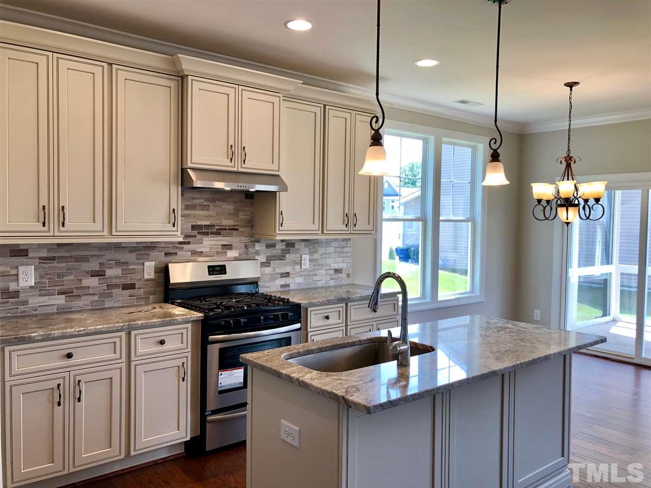 3717 Massey Ridge Court Raleigh, NC 27616 - Photo 6 of 24 a kitchen with white cabinets and appliances