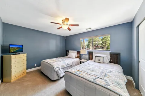 a bedroom with two beds and a chandelier