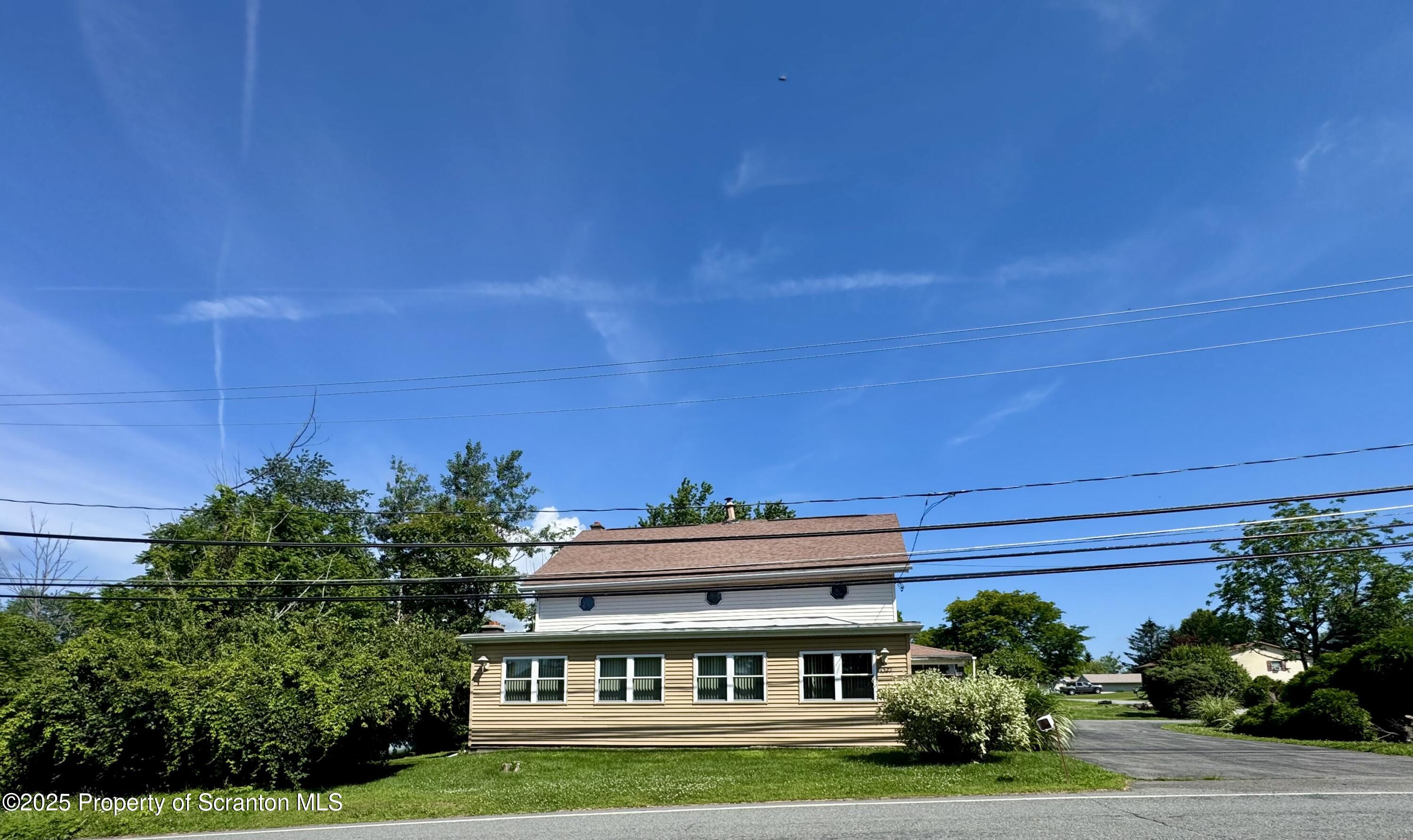 a view of house with garden space and trees