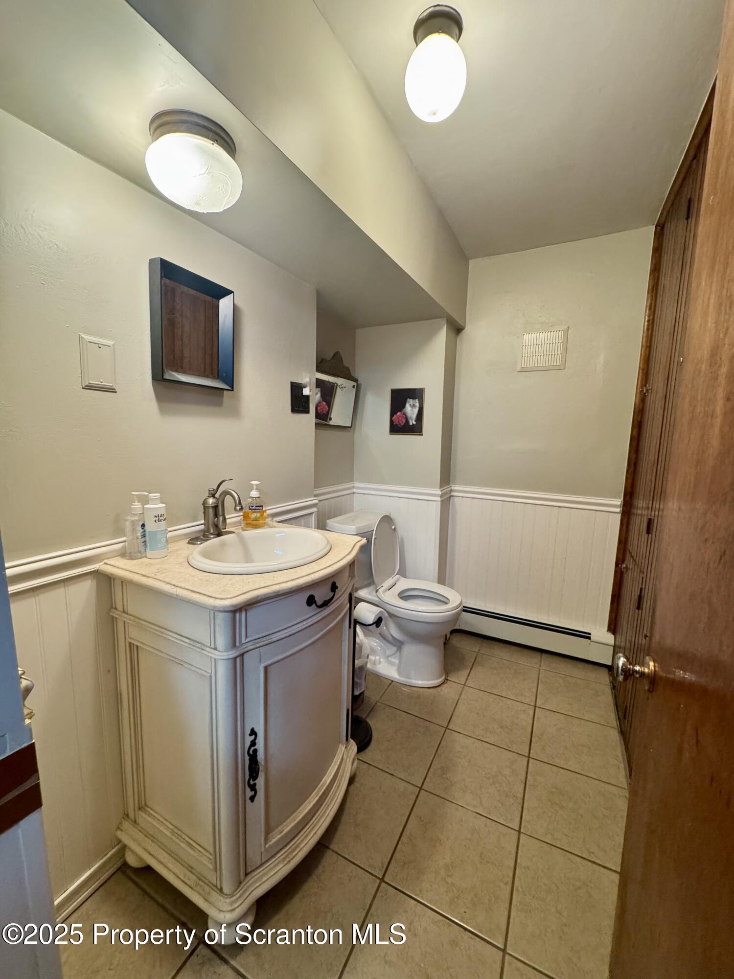 1325 Fairview Road Clarks Summit, PA 18411 - Photo 17 of 21 a view of bathroom with a toilet sink and mirror