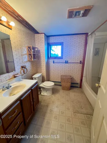 a view of bedroom with furniture and wooden floor