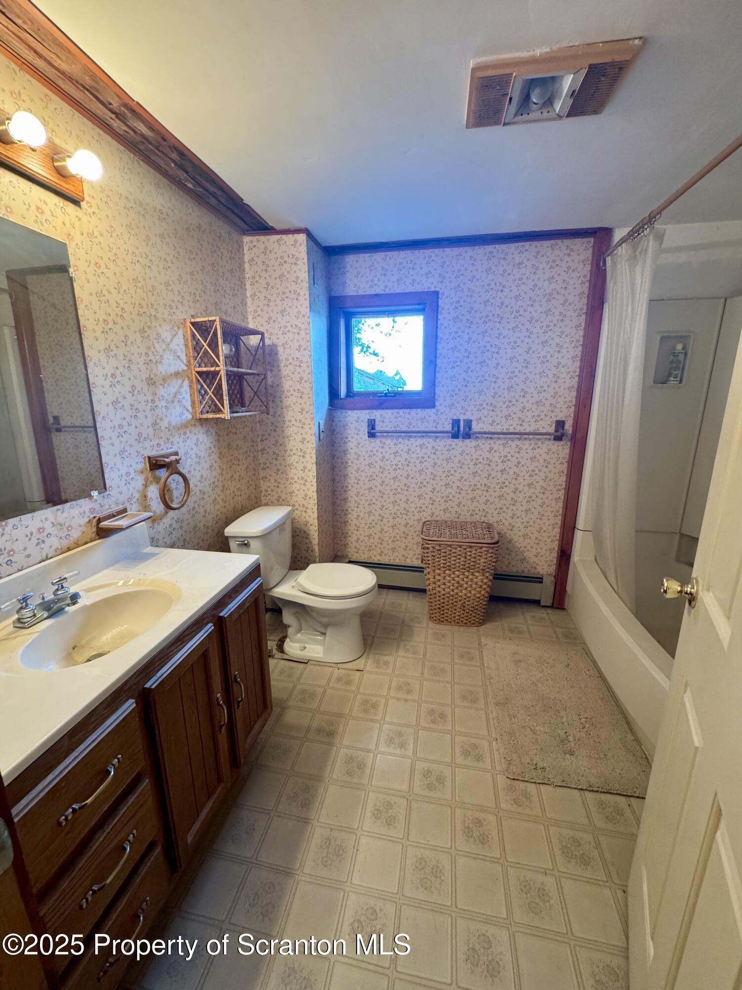 1325 Fairview Road Clarks Summit, PA 18411 - Photo 18 of 21 a bathroom with a sink a toilet and a mirror