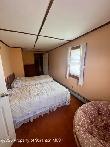 a bedroom with furniture and a window